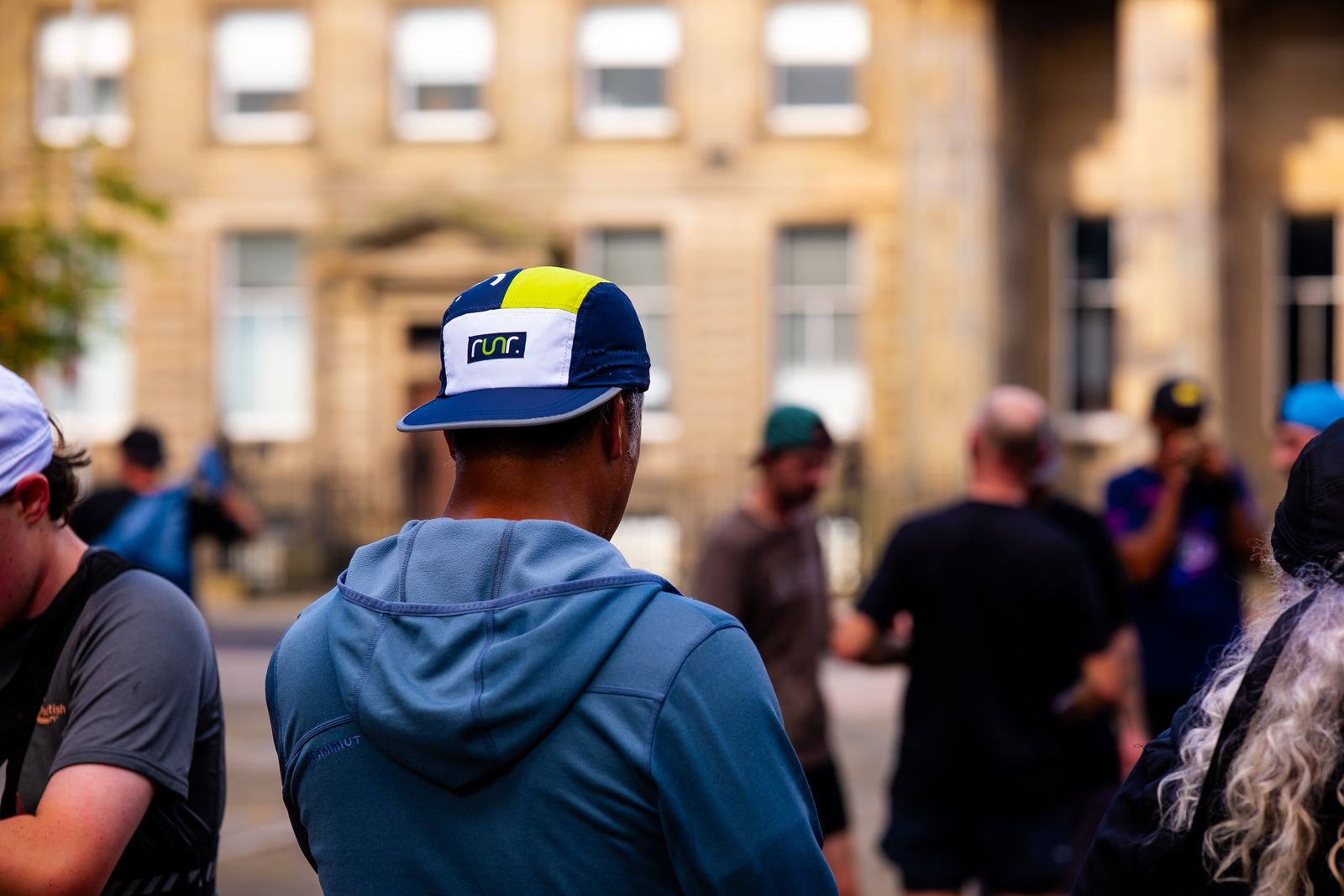 A runner wearing a runr hat among attendees at the Glasgow event