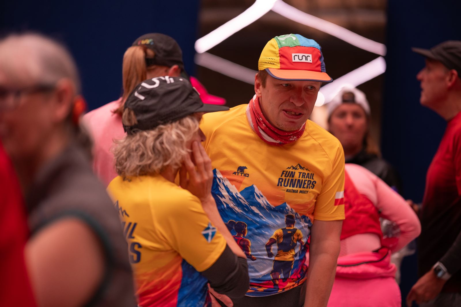 Runners chatting in their runr hats at the social